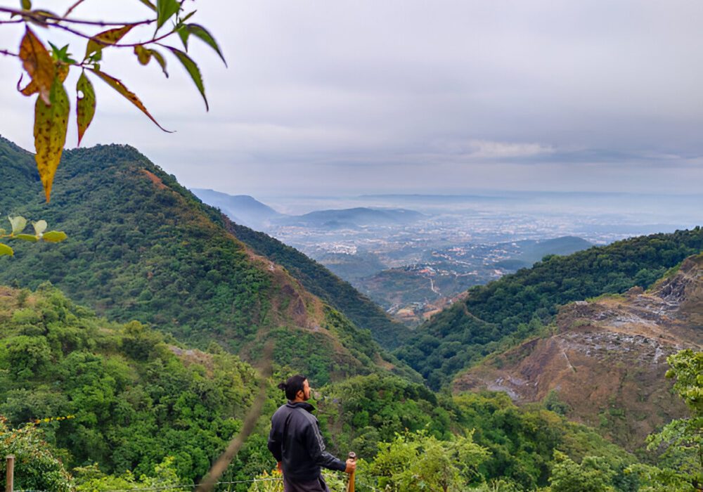 An aerial shot of Mussoorie’s lush green hills with winding roads leading to the George Everest House.